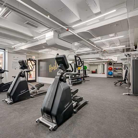 a gym with treadmills and other exercise equipment in a building