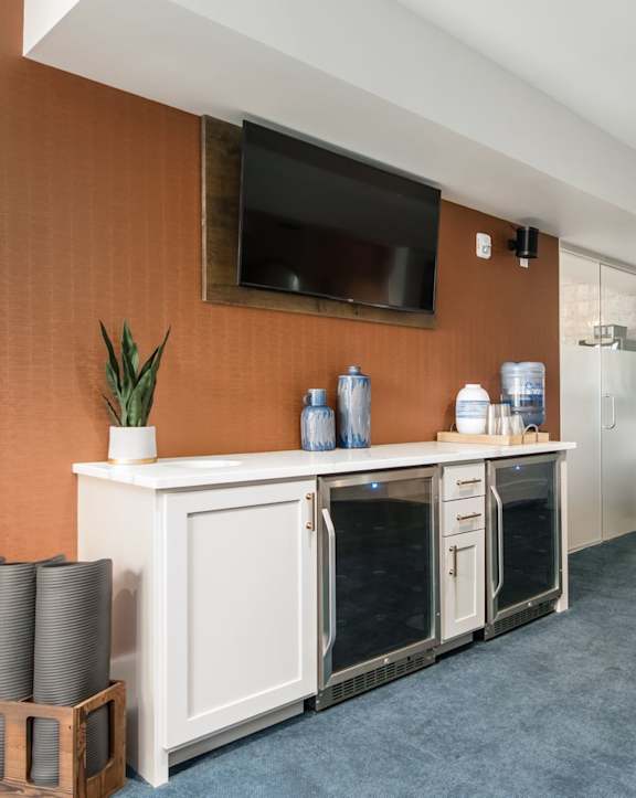 a gym with a counter and a tv in the corner of a room
