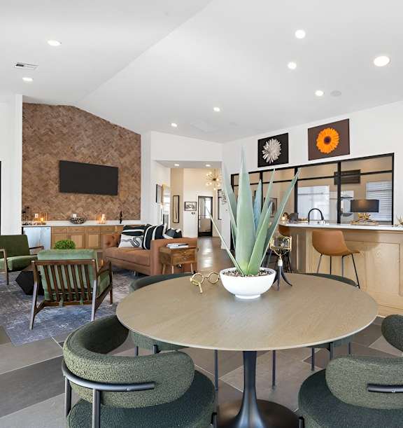 A modern dining room with a round table and chairs.