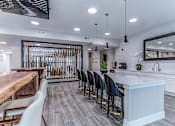 Thumbnail 2 of 31 - A modern kitchen with a long white island and bar stools.at Tiffany Flats, Columbus, OH, 43231