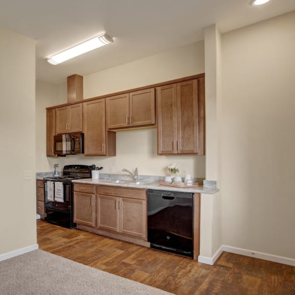 a kitchen with wooden cabinets and a sink and a stove