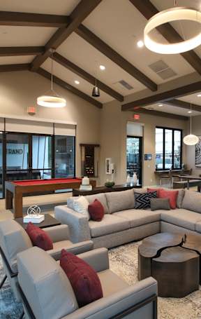 clubroom with a large grey sofa and a coffee table.