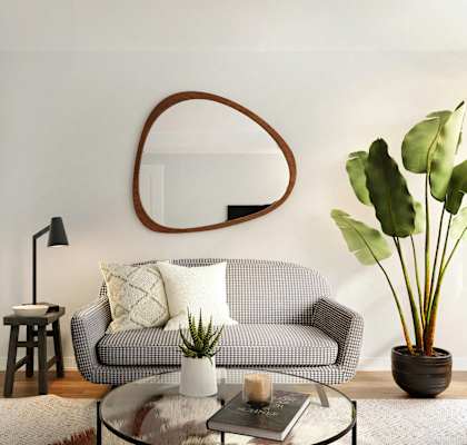 a living room with a couch and a mirror on the wall