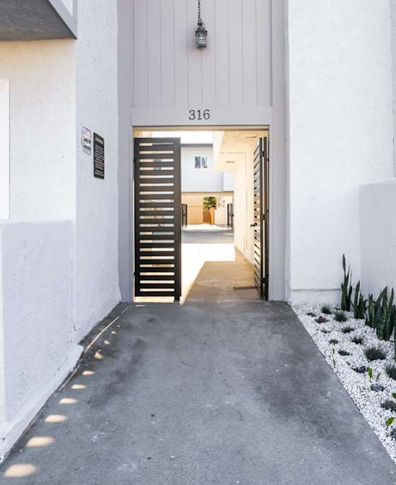 Ocean Edge at Laguna Beach modern kitchen with a bar stool and a couch.