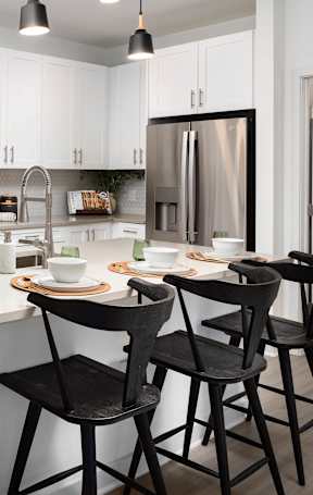 A modern kitchen with white cabinets and a central island.