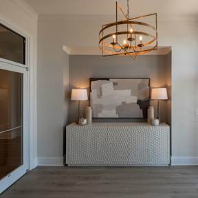A modern bedroom with a large bed and a chandelier.