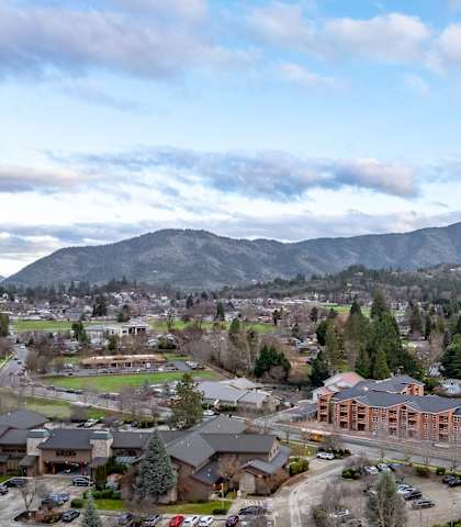 A mountainous landscape with a town in the foreground.