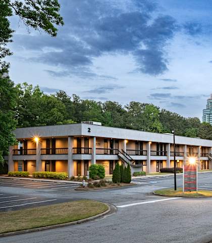 A large building with a parking lot in front of it.