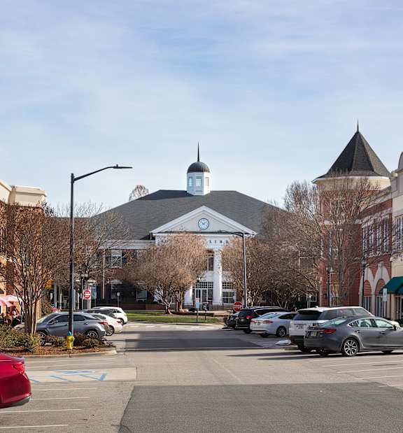A parking lot with cars and a building with a sign that says Mendocino Farms.