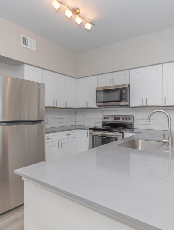 a kitchen with stainless steel appliances and a sink