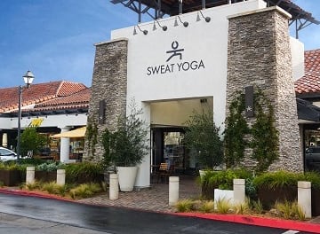 the front of a restaurant with cars parked outside