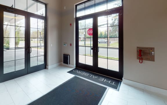 a lobby of a building with doors and a sign that reads city hall