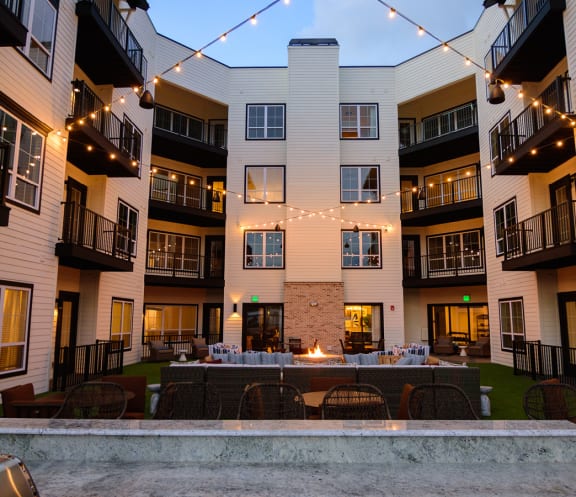 a courtyard with a fire pit in the middle of an apartment building