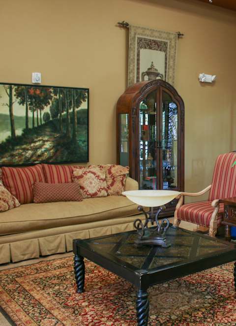 A living room with a sofa, armchair, and coffee table.