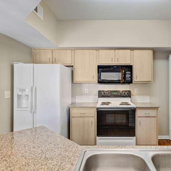 A reception area with a white counter and a brown chair.