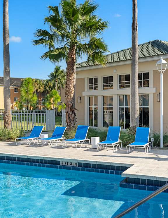 A pool with a building behind it.