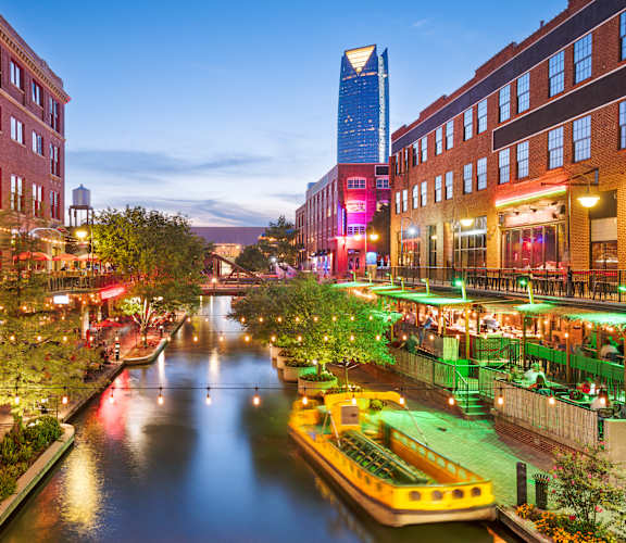 A canal with a boat and buildings on both sides.