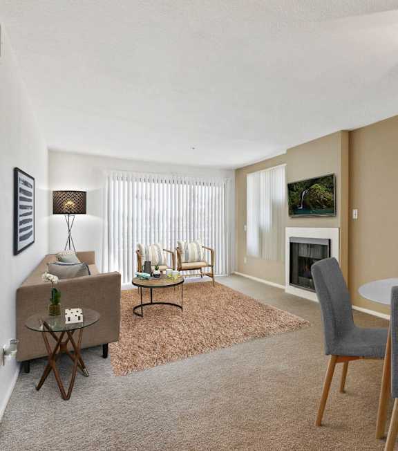 a living room with a spiral staircase and a couch and a table at Bixby Knolls, Long Beach, CA
