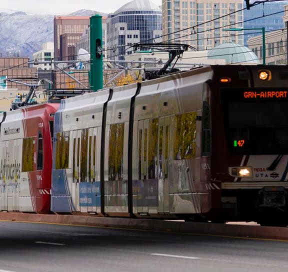 a train is traveling down the tracks in a city