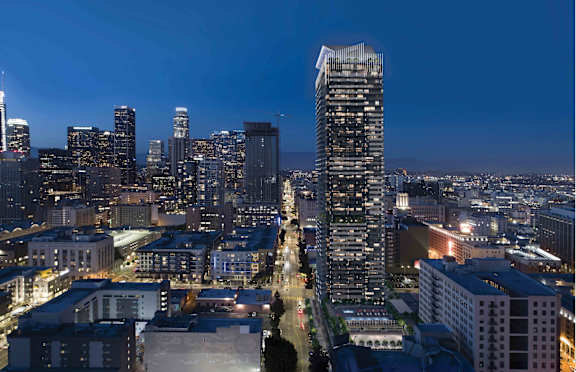 A cityscape at night with a tall building in the foreground.