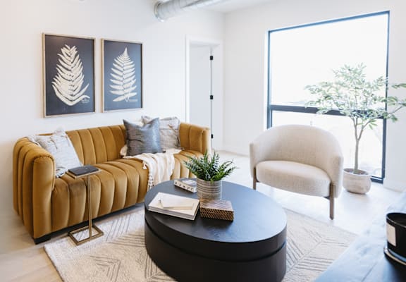 a living room with a brown couch and a coffee table