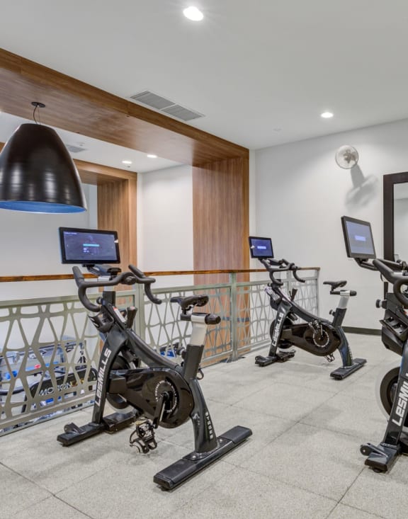 a room filled with lots of different types of exercise bikes