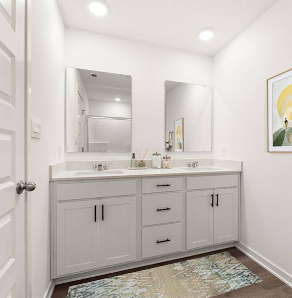 A white crib sits in a room with a framed picture of a giraffe on the wall.