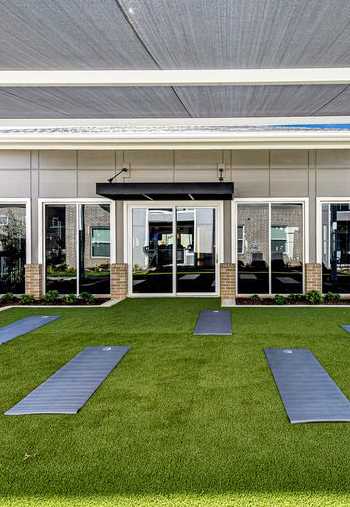 A yoga studio with a white roof and a glass wall.