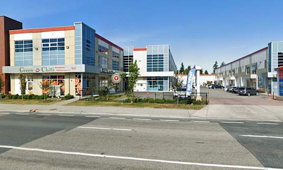 A street view of a commercial area with a clear blue sky.