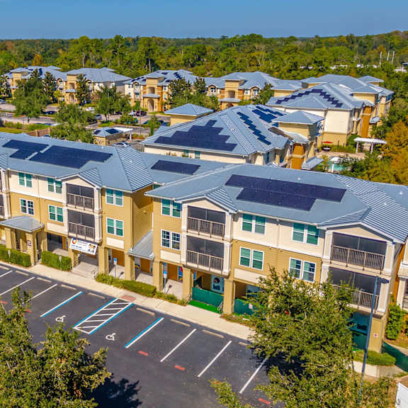 an apartment building with a sidewalk in front of it