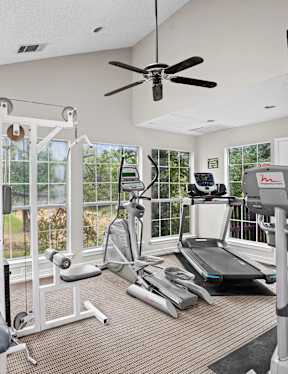 the gym has a lot of equipment in it