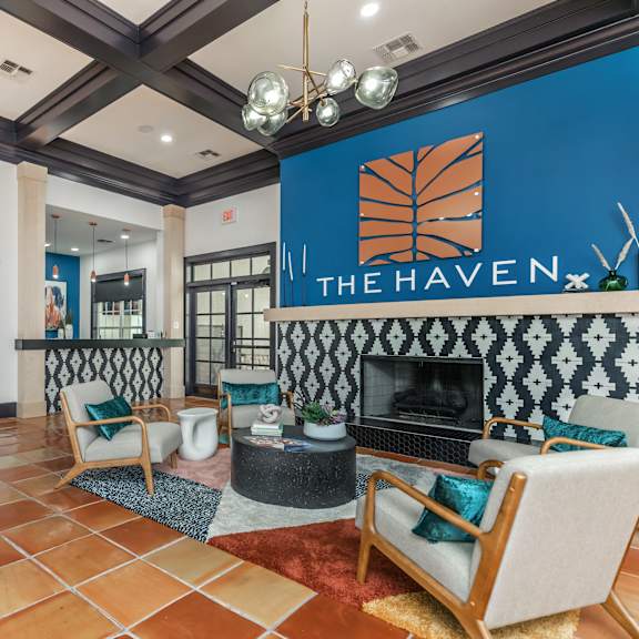 A living room with a fireplace and a sign that says "The Haven.".