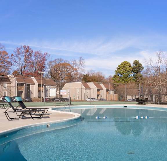 A large swimming pool with a blue tinted water. at Lakes Edge Apartments, Apartments, Greensboro, NC