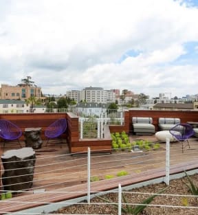 a rooftop deck with a view of the city