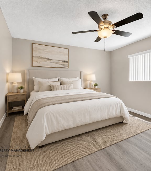 A bedroom with a large bed and a ceiling fan.
