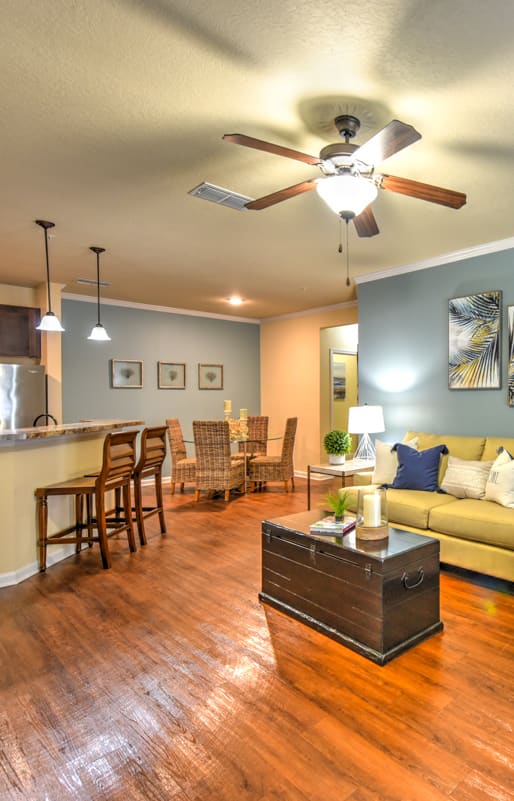 a living room with a ceiling fan and hardwood floors at Cabana Club Apartments in Florida 32256