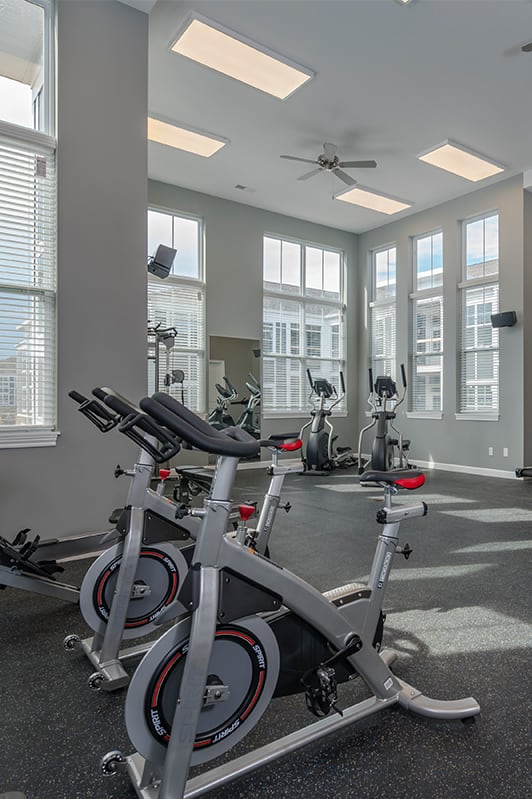 an indoor gym with exercise bikes and windows