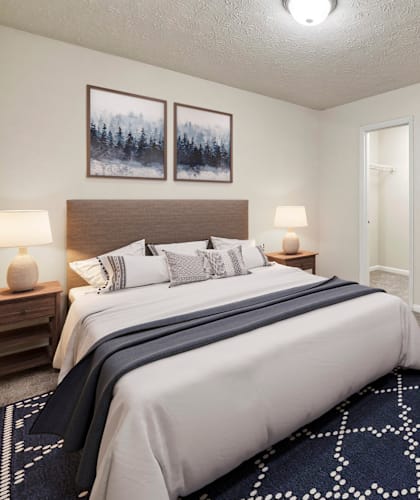 a bedroom with a large bed and a closet at Bradford Gwinnett Apartments in Norcross, Georgia 30071