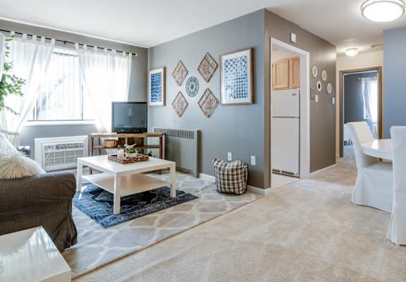 a living room with blue walls and a white coffee table