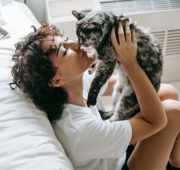 Woman Laying in Bed with a Cat at The Locks Tower in Richmond, VA 23219