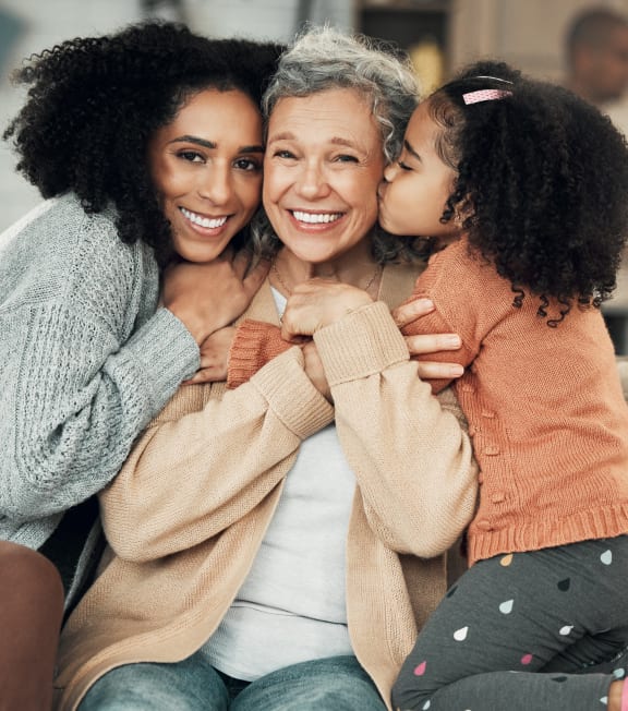 a woman sitting on a couch with her daughter