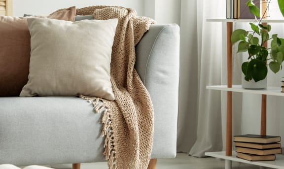 a living room with a couch and pillows on it