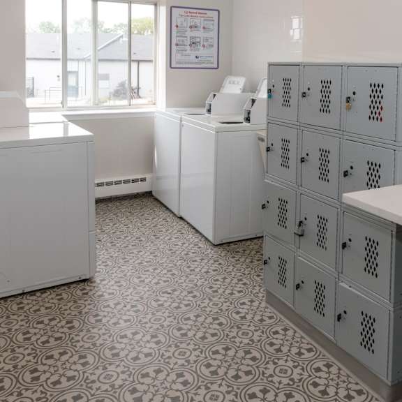A room with white cabinets and a patterned floor.