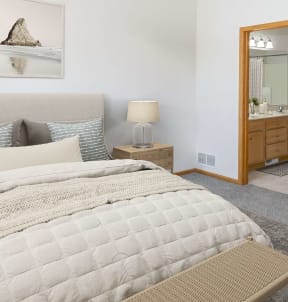 a bedroom with a bed and a closet with a mirror