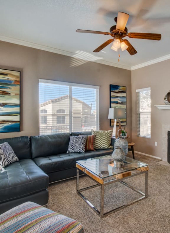 a living room with a couch and a coffee table in front of a fireplace at Arterra, Albuquerque, NM, 87113