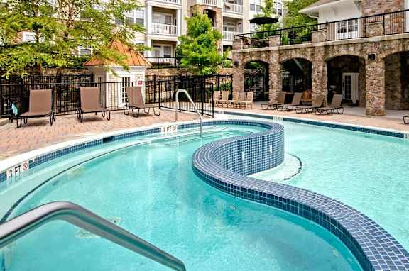 A large outdoor swimming pool with a slide.