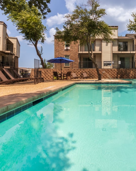 This is a photo of the pool area at Canyon Creek Apartments in Dallas, TX.