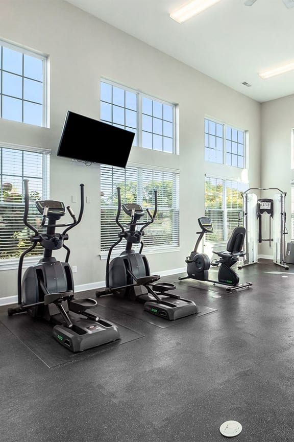 the estates at tanglewoodfitness gym with windows and cardio equipment