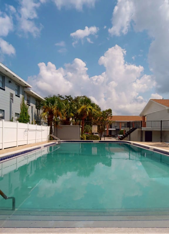 swimming pool and lounge chairs at Lakeland Manor Apartments