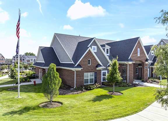 A house with a flag on a pole in front of it at Village Place Apartments, Romeoville, 60446